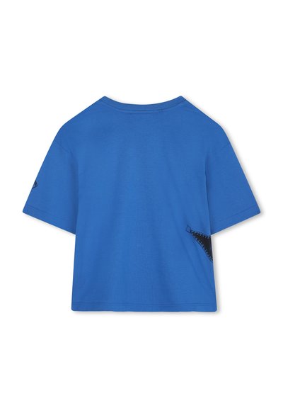 Korte mouw t-shirt van helderblauw katoen, met een zwarte accent en geometrische stitching aan de linkerkant en een ronde halslijn.