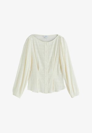 Kermanvärinen paita teksturoidusta kankaasta, pyöreä pääntie, edessä nappikiinnitys ja pitkät hihat kerätyillä kalvosimilla.