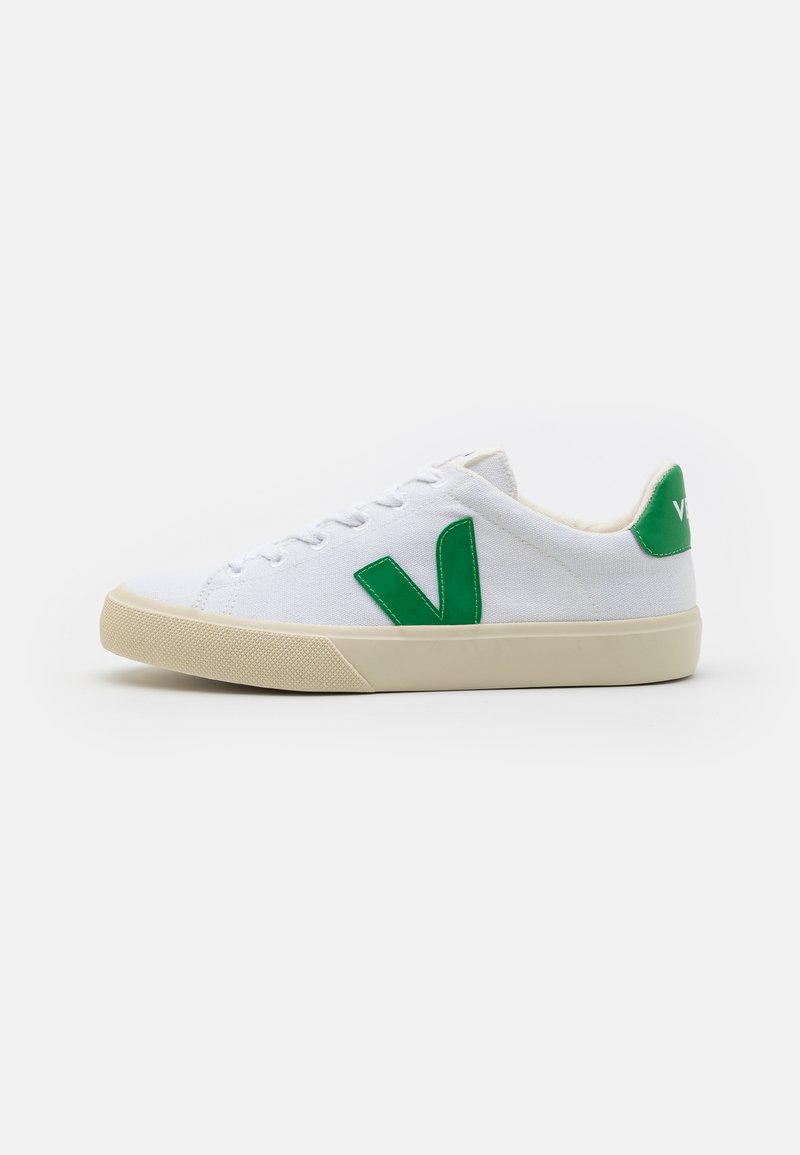 Sneaker di tela bianca con logo "V" verde in gomma e tallone verde. Presenta lacci bianchi e una suola in gomma beige texturizzata.