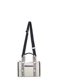 Kangas käsilaukku béžissä mustilla yksityiskohdilla, joka sisältää säädettävät hihnat ja kohokuvionnin logon. Suorakulmainen muoto, jossa ulkopuolinen vetoketjullinen tasku.