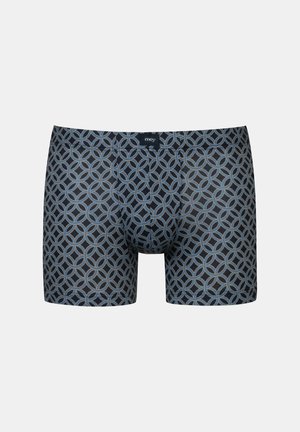 Boxer shorts featuring a dark blue fabric with a repetitive geometric circle pattern in lighter blue and beige tones. Soft texture, elastic waistband.
