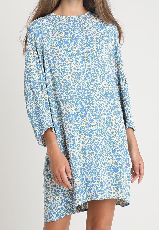 Robe à imprimé floral avec une coupe ample, palette de couleurs bleu et crème, manches trois-quarts et encolure ronde. Tissu doux.