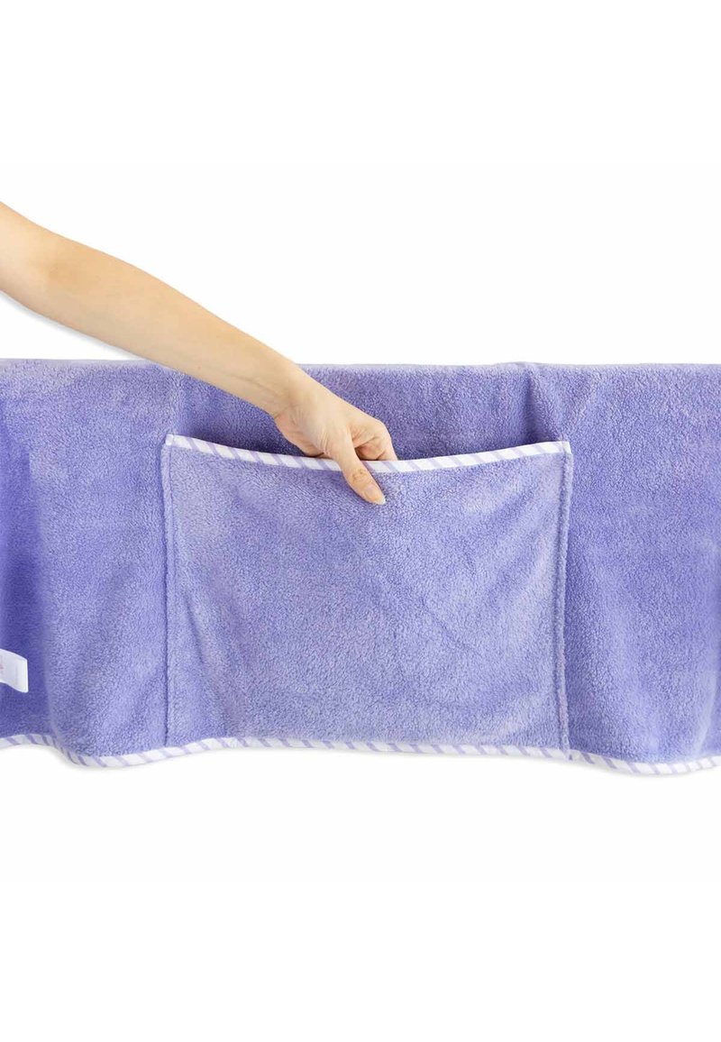 Lavender towel with plush texture, featuring a large pocket and striped trim along the edges. Hand is shown holding the pocket.