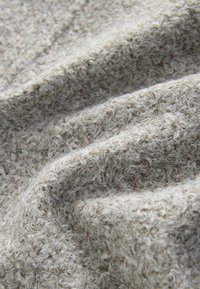 Light gray textured fabric with a soft, fuzzy surface, showcasing a crinkled pattern and variations in yarn thickness.