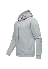 Lys grå zip-up hættetrøje med en blød tekstur, justerbar hætte, sidelommer og ribbede manchetter. Har et minimalt logo på ærmet.