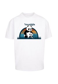 White cotton t-shirt featuring a graphic of a parent and baby panda in front of a multicolored sunset. Text above reads "Nostalgia."