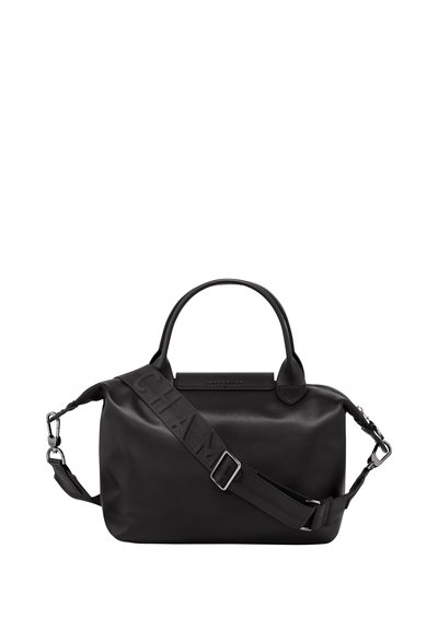 Black handbag made of smooth material, featuring a rounded shape, dual handles, and a detachable strap with a logo. Minimalist design.