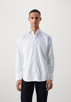 White long-sleeve shirt with a classic collar and button-down front, made of smooth fabric. Includes curved hem and cuffs.