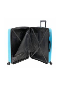 Maleta rígida de color azul brillante con interior negro, que cuenta con un compartimento dividido, correas ajustables y ruedas dobles giratorias suaves.