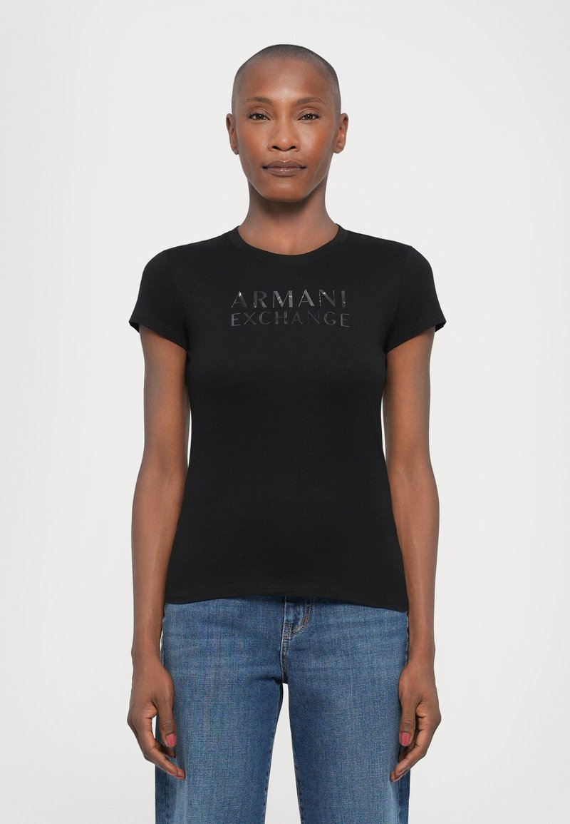 Black short-sleeve t-shirt with a round neckline, featuring a glossy "ARMANI EXCHANGE" logo on the front. Soft, fitted fabric.