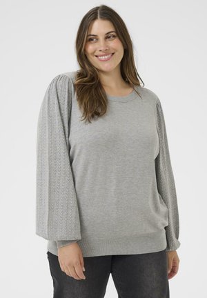 Gray knit sweater with textured, patterned puff sleeves, round neckline, and ribbed hem, paired with dark jeans.