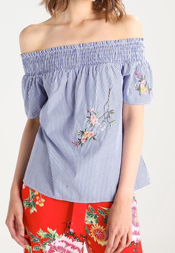 Off-the-shoulder striped top in blue and white, featuring floral embroidery on the front and relaxed short sleeves.