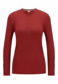 Pull rouge en maille côtelée avec manches longues, encolure ronde et boutons décoratifs aux poignets. Texture douce et coupe ajustée.