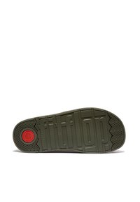 Groene rubberen buitenzool met het 'fitflop' logo, tekstuur met een chevronpatroon en een ronde rode accent bij de hiel.
