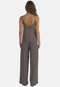 Set di abbigliamento informale grigio composto da una maglietta senza maniche con scollatura a V profonda e pantaloni a gamba larga, entrambi realizzati in tessuto morbido e leggero.
