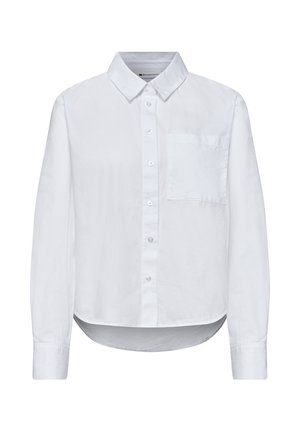 Chemise blanche à manches longues avec boutons, col et poche poitrine, dotée d’un ourlet arrondi et de poignets à boutons.