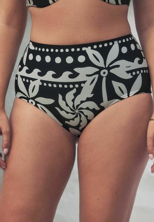 Bas de bikini taille haute noir avec de grands motifs floraux et des pois blancs, présentant une texture lisse et un ajustement snug.