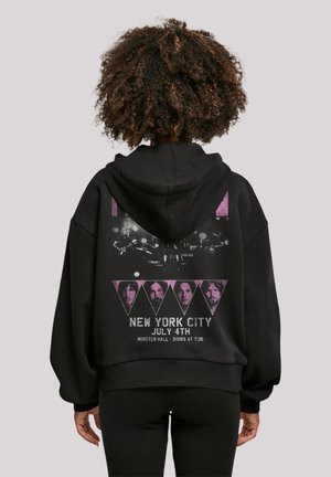 Black oversized hoodie with a graphic print on the back featuring triangular shapes, text, and images in purple and white. Soft fabric texture.