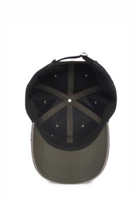 Black cap with a flat brim, olive green underside, and reinforced seams. Interior features ventilation holes and a snapback closure.