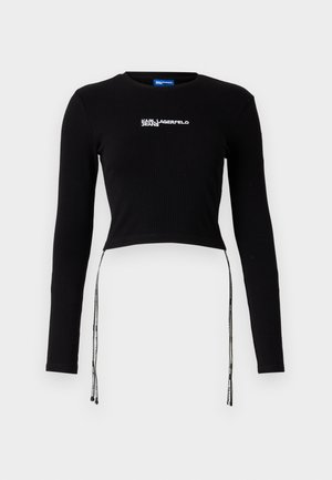 Crni rebrasti kratki top s dugim rukavima, s okruglim izrezom i podesivim vezicama na rubu. Uključuje logo "Karl Lagerfeld Jeans".