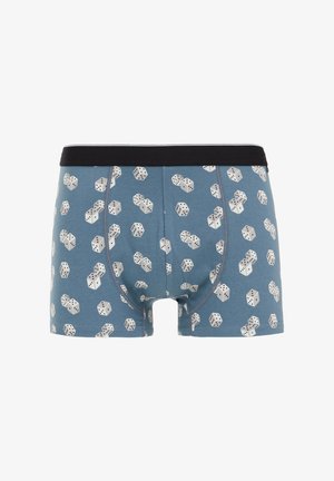 Shorts en coton bleus avec une taille noire, présentant un motif répétitif de dés blancs. Texture douce et design ajusté.