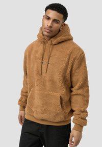 Brown, fleece hoodie with a textured finish, front pocket, and adjustable drawstring. Ribbed cuffs and hem complete the design.