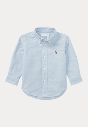 Chemise bleu clair à manches longues avec patte de boutonnage, col boutonné et petit logo brodé de cheval sur la poitrine gauche.