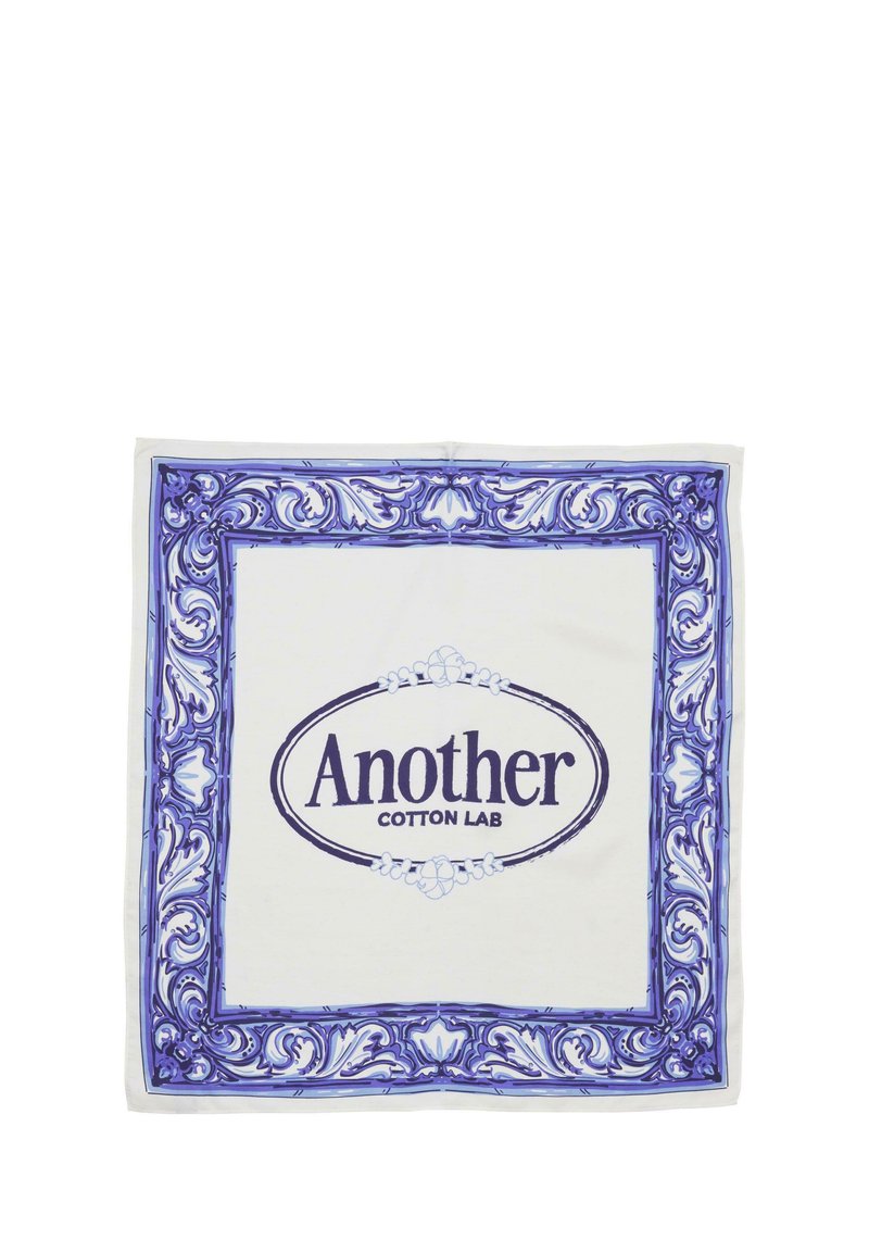 White cotton scarf featuring a blue ornate floral border. Center displays "Another Cotton Lab" in bold purple lettering.
