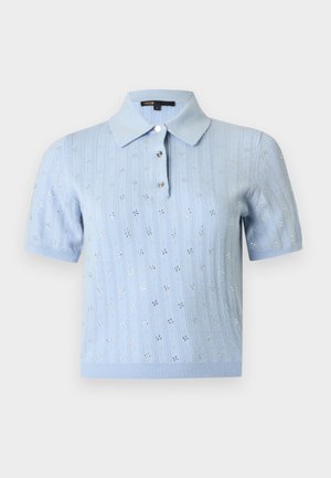 Polo en tricot bleu clair à manches courtes avec motif floral en œillets et trois boutons sur le devant, sur un fond uni.
