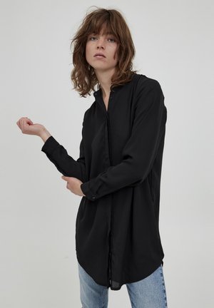 Black long-sleeve shirt made of a smooth fabric, featuring a buttoned front, collared neck, and a loose fit with curved hem.