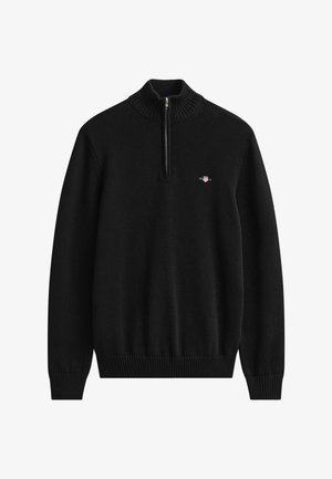 Pull en maille noir à manches longues avec poignets et ourlet côtelés, demi-fermeture éclair sur le devant et petit logo brodé sur la poitrine gauche.