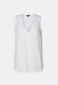 Top branco sem mangas com um decote em V, apresentando um acabamento com babados. Feito de tecido leve com um corte descontraído. Sem fechos visíveis.