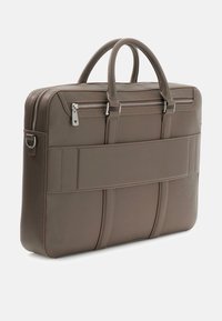 Brown leather laptop bag with dual top handles, a zip closure, and horizontal stitching accents. Features a flat panel and smooth texture.