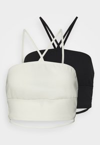 Conjunto de bralette em preto e branco, composto por um tecido suave, alças finas ajustáveis e um design simples com uma silhueta ajustada.
