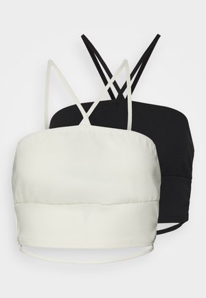 Conjunto de bralette em preto e branco, composto por um tecido suave, alças finas ajustáveis e um design simples com uma silhueta ajustada.