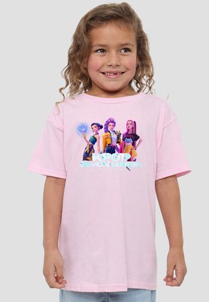Young girl with curly hair wearing a pink T-shirt featuring three animated female K-pop characters and the text "KPOP DEMON HUNTERS."