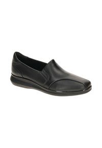 Zapatos negros sin cordones hechos de cuero suave, con punta redondeada, detalles de costura sutiles y una suela de goma de perfil bajo.