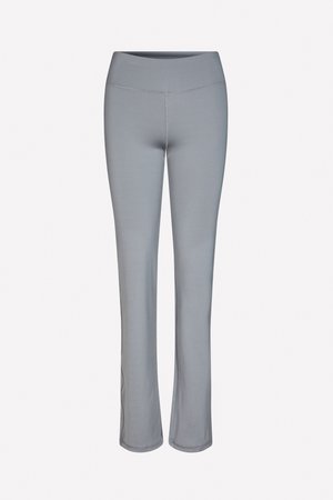 Gray stretch leggings with a mid-rise waistband, fitted design, and flared bottoms. Smooth texture and minimal stitching details.