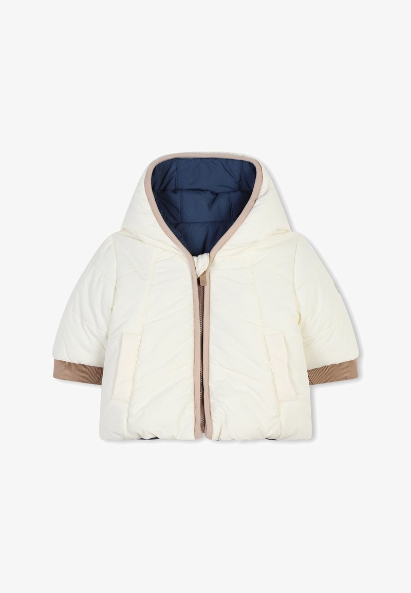 Veste matelassée crème avec capuche, poignets marron et doublure bleue contrastante. Dotée d'une fermeture à l'avant et de poches latérales.
