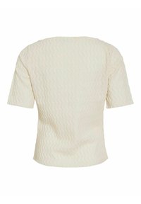 Top corto de manga corta en color crema, con un patrón texturizado y detalles en forma de olas, escote redondo y un ajuste relajado.