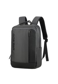 Sac à dos gris de forme rectangulaire, fabriqué en tissu durable. Il dispose de bretelles ajustables, de plusieurs poches et d'un logo sur le devant.