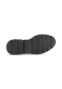 Black rubber shoe sole featuring a textured surface with horizontal grooves and a logo. Durable material designed for traction and comfort.