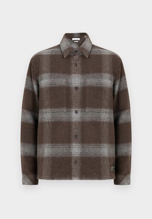 Brun och grå rutigt flanellskjorta med knäppning fram, långa ärmar och mjuk textur. Har en liten logopatch i nederkant.