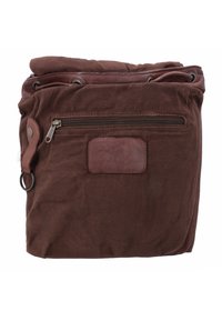 Brown suede and leather backpack with a top drawstring closure, front zippered pocket, and a side leather strap with metal ring.