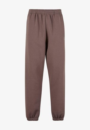 Brązowe dresy wykonane z miękkiego materiału, z elastyczną talią, ściągaczami na kostkach i małym logo na lewym udzie.