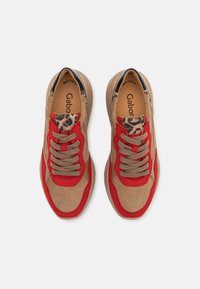 Red and beige sneakers with suede and textile materials, featuring leopard print accents, round toe, and lace-up design.