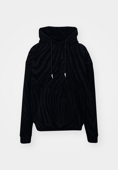 Hanorac negru cu glugă, prezentând un model texturat cu dungi de zebra. Sireturi cu capete metalice ascuțite și mansete ribbate la mâneci și la tiv.