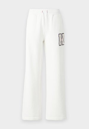 Witte sweatpants met een losse pasvorm, voorzien van een geborduurde letter "H" op het linkerbeen, een elastische tailleband en een trekkoordsluiting.