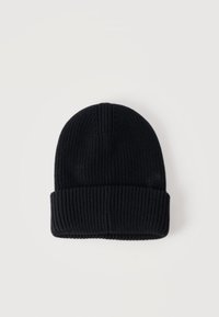 Μαύρο πλεκτό σκουφάκι με ριμπ ύφανση και διπλωμένο στρίφωμα, απεικονίζεται επίπεδο πάνω σε ουδέτερο ανοιχτό φόντο.