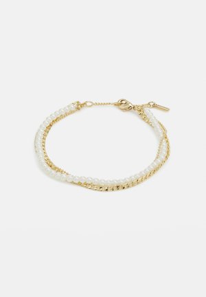 Gold bracelet featuring two strands: one with white pearls and another with a twisted chain design. Clasp closure with a small tag.
